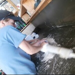 Laura rolls the felt as tight as she can